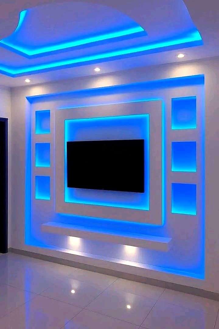 LED-lit gypsum ceiling and TV wall feature with blue accent lighting