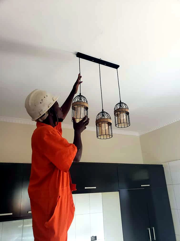 Technician installing a pendant light fitting