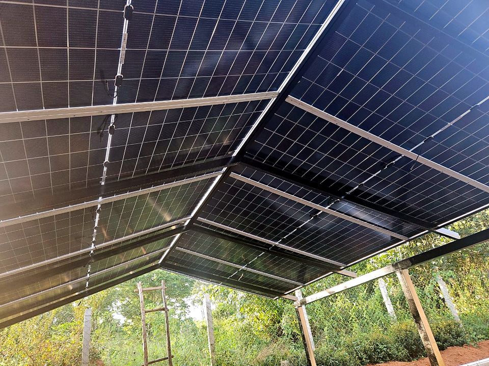 Underside view of a solar carport with panels on a steel frame