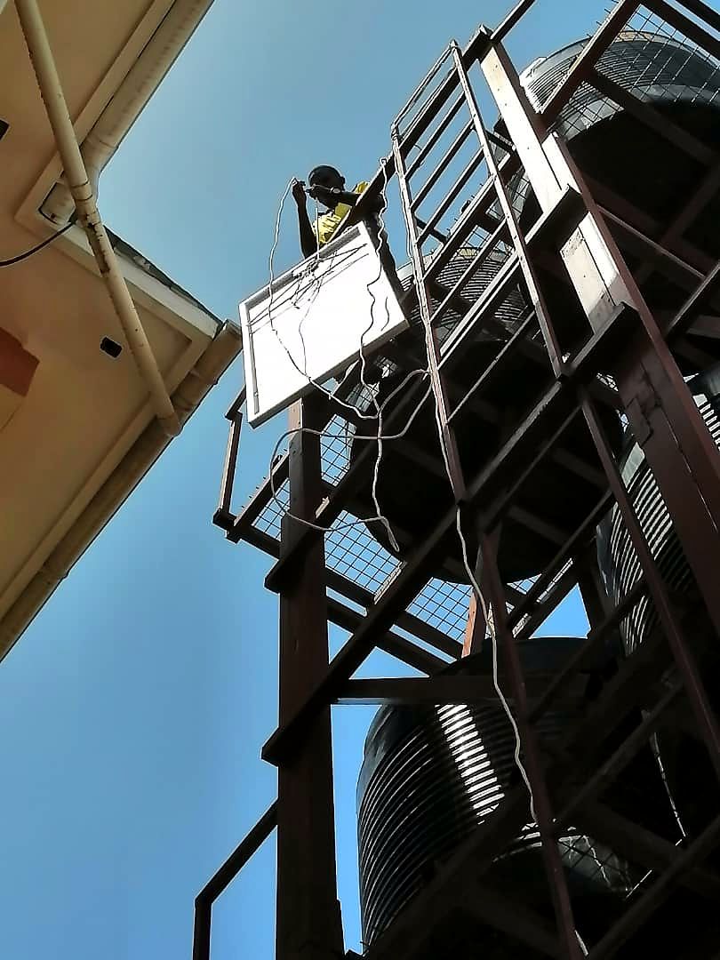 Technician working at the top of a steel water tank tower